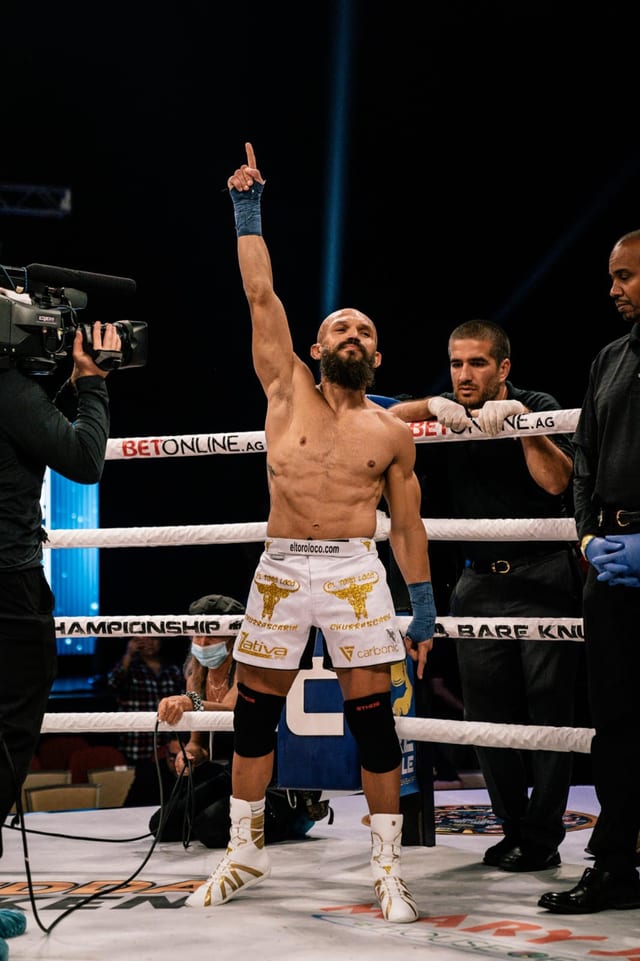 Edgard Plazaola with one arm raised in the ring after his bare-knuckle bout